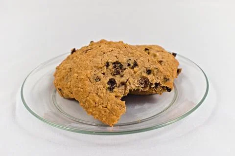 Three Oatmeal Cookies Missing a Bite on Glass Plate Stock Photos