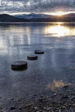Three objects lead to setting sun. Foto stock
