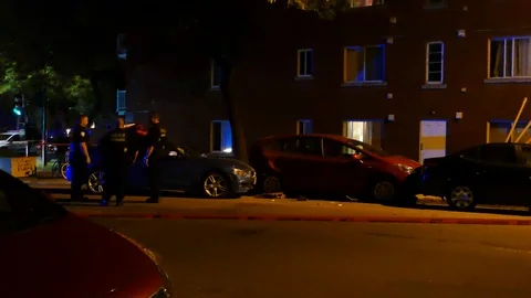 Three officers talking in front of a car crash at night Stock Footage 95735198