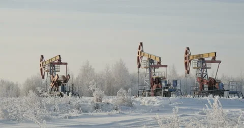 Three oil rigs on the background of the winter landscape Stock Footage 102478789
