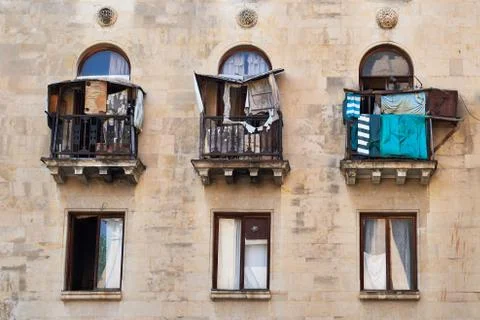 Three old balconies with windows Stock Photos
