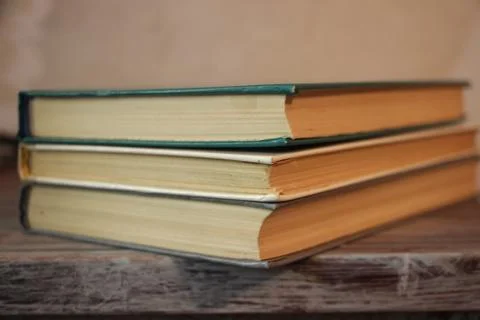 Three old books in a library. Knowledge education concept Stockfoto's