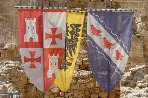 Three old Crusaders flags and coat of arms Stock Photos