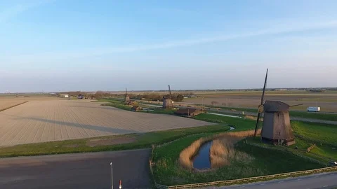 Three old dutch windmills with birds flying around and a great view shot by a dr Stock Footage