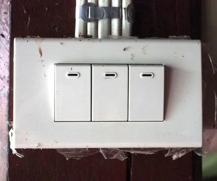 Three old electric rectangle switch on old wood wall with some dust Stock Photos