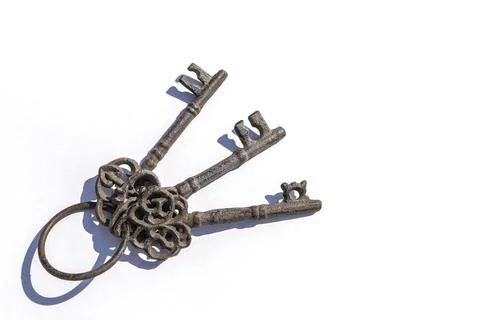 Three old keys on a white background Stock Photos