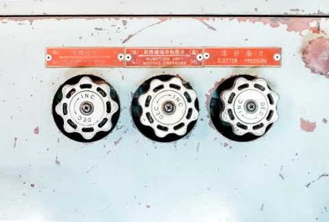 Three of old machine valve on rustic metal Stock Photos