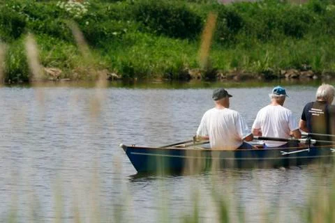 Three old men rowing Stock Photos