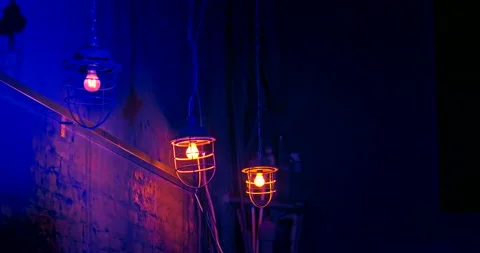 Three old metal lanterns hanging on long chains in nightclub. Interior design. 스톡 동영상 201299375