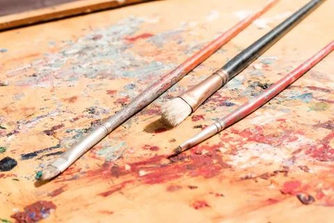 Three old paintbrushes Stock Photos