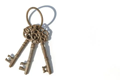 Three old rusty brown keys on a white background Stock Photos