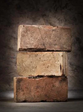 Three old used red clay bricks stacked 写真素材