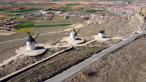 Three old windmills in line and the Castillo de la Muela on the top of the hill Stock Footage 257778021