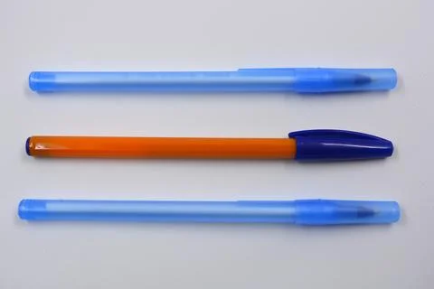 Three open handles made of blue, yellow caps on a white background. Stock Photos
