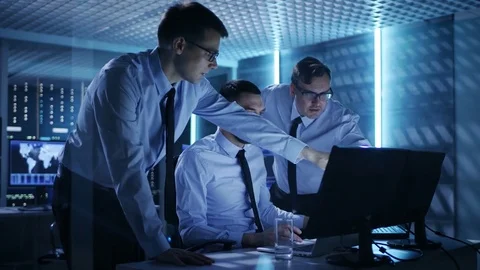 Three Operations Engineers Solving Problem in a Monitoring Room. Stock Footage 75004000
