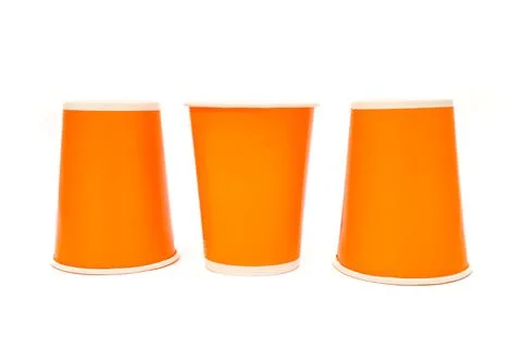 Three orange disposable cups isolated on white, arranged symmetrically, sho.. Stock Photos