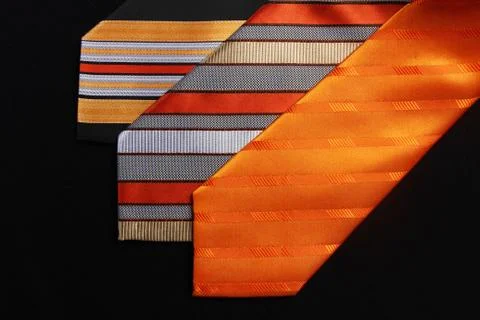 Three orange ties on blackbackground Foto stock
