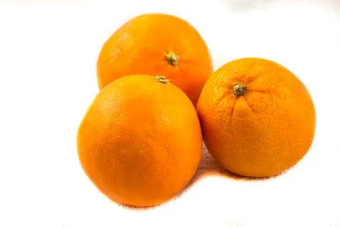 Three oranges on paper with white background Stock Photos