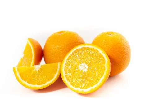 Three oranges on a white background one cut into three parts Stock Photos