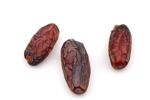 Three organic Medjool dried date fruits isolated on white background Stock Photos