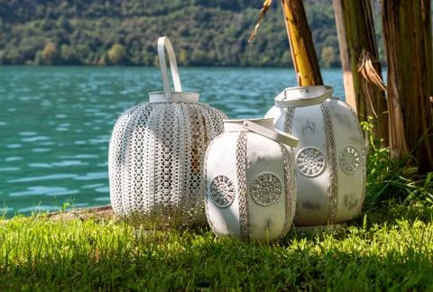 Three oriental white rustic lanterns outdoors on the grass Stock Photos