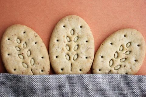 Three oval multigrain biscuits under canvas closeup Stock Photos