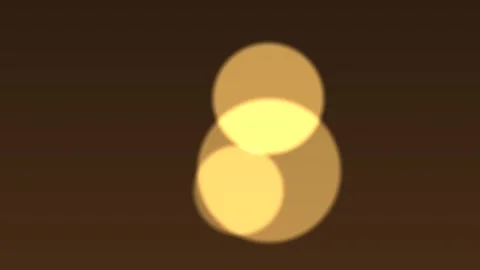 Three overlapping circles in yellow and brown on dark brown background Stock Footage 329009458