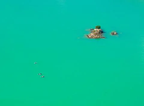 Three paddleboards float away from island in Diablo Lake in North Cascades Stock Photos