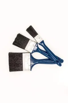Three paint brushes with blue colored Stock Photos