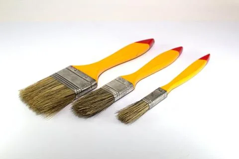 Three paint brushes with a width of 1 inch, 2 inches and 0.5 inches Stock Photos