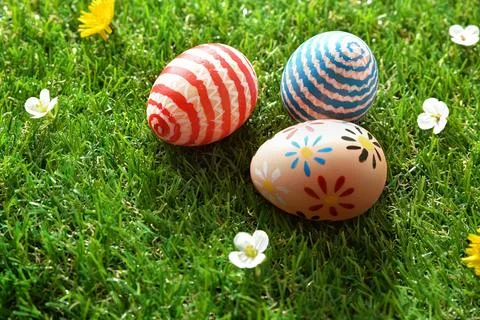Three Painted Easter Eggs on Green Grass Stock Photos