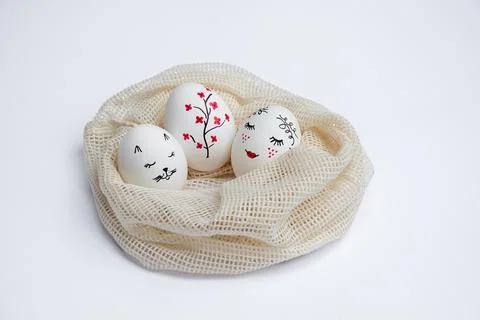 Three painted Easter eggs in mesh bag Stock Photos