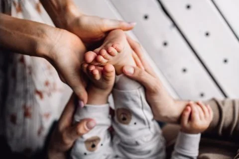 Three pair of hands holding together. Mother, father and child taking each other Stock Photos