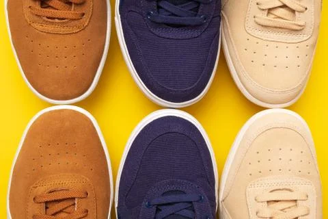 Three pair of sneakers on colored background Stock Photos