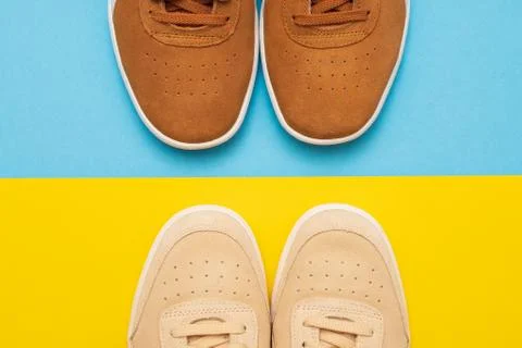 Three pair of sneakers on colored background Stock Photos