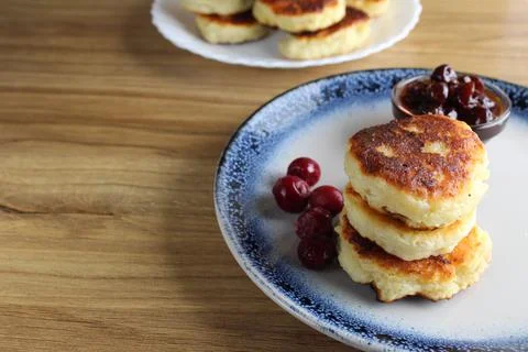 Three pancake cheesecakes lie a stack of slides on top of each other on a pla Stock Photos