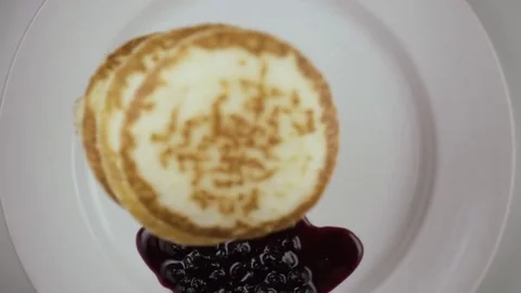 Three pancakes fall on the plate. Slow motion. Top view Stock Footage 75034368