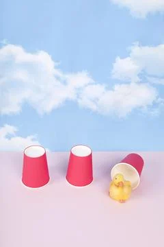 Three paper cups are used to play the game of bonneteau and a duck under on.. Stock Photos