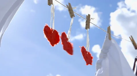 Three Paper Hearts on a Clothesline Stock-Footage 62384223