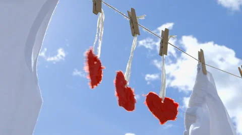 Three Paper Hearts on a Clothesline Stock-Footage 62384304