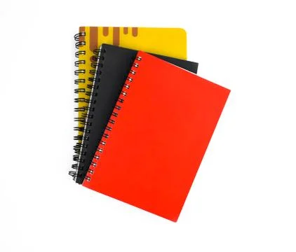 Three paper note diary of red black and yellow color placed on top of each ot Foto stock