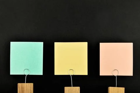 Three paper notes with holder isolated on black for presentation Three pap... Stock Photos