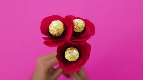 Three paper red rose flower with chocolate in the center Stock Footage 168727003