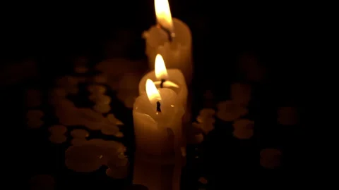 Three Paraffin Candles Burn in a Row on a Black Background with Reflection Stock Footage 263553345