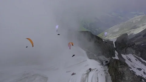 Three paraglider gliding over the snow covered mountains 스톡 동영상 76003533