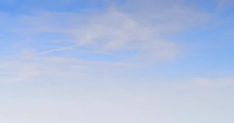 Three Paragliders Drifting Across Clear Blue Sky Stock Footage 336443099