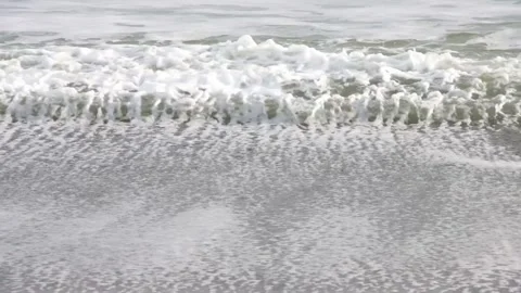 Three parallel frothy sea water waves breaking on sandy beach Stock-Footage 303256488