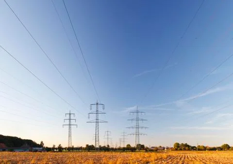 Three parallel power line tracks with blue sky. Stockfoto's