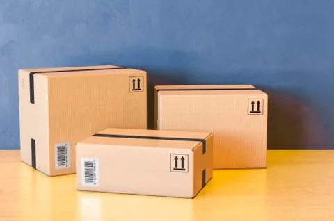 Three parcels. Shipping and logistics on the wooden table. 3D rendering Illustrazione stock