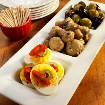 Three Part Serving Dish with Deviled eggs, Marinated Mushrooms and Olives; Bowl 스톡 사진